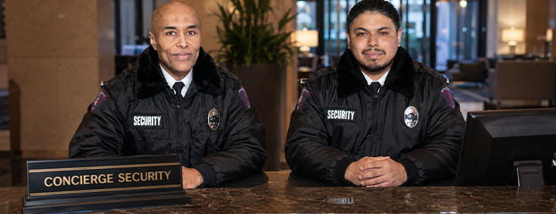 Two security officers working in lobby at desk
